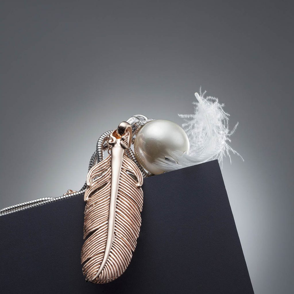 Pear with feather. Jewelshot for online campaign